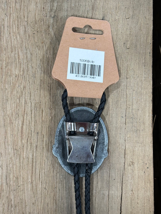Metal clip with black cord on a cardboard backing with a barcode on a wooden surface