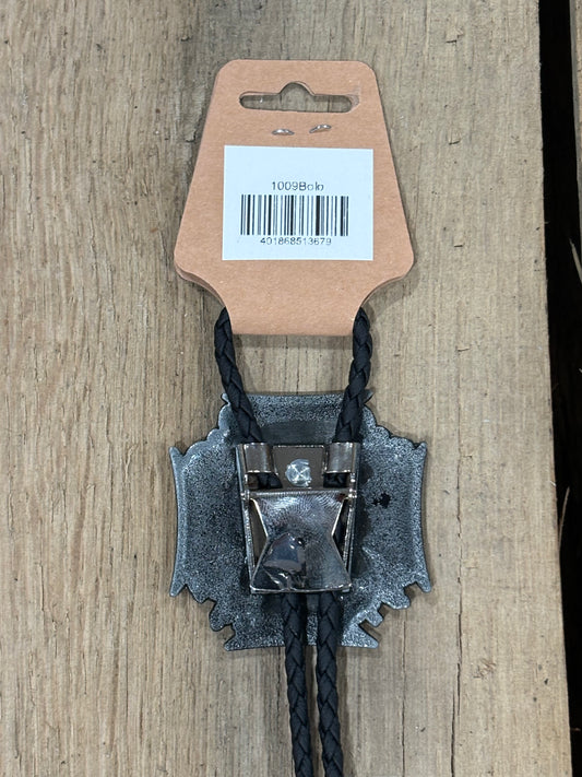 Metal clip with black cord on a cardboard backing with a barcode on a wooden surface