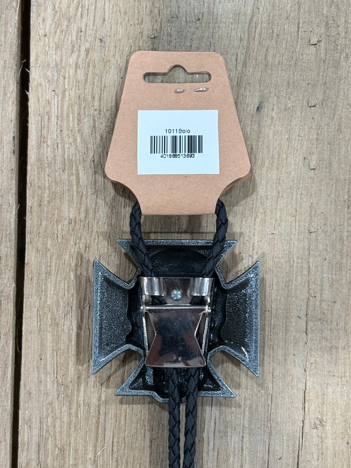 Metal clip with black cord on a cardboard backing with a barcode on a wooden surface