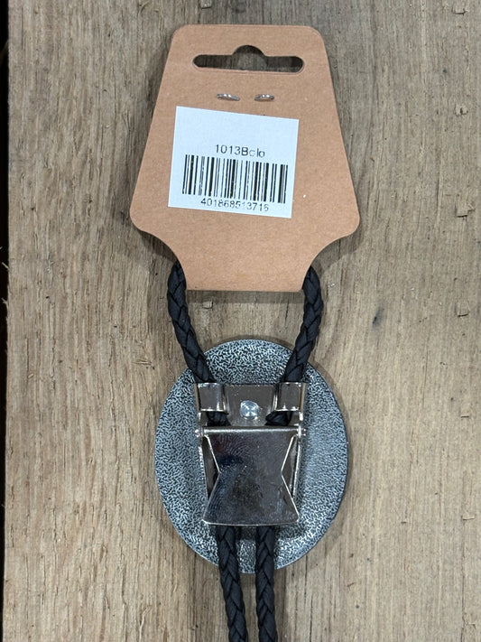 Metal clip with black cord on a cardboard backing with a barcode on a wooden surface