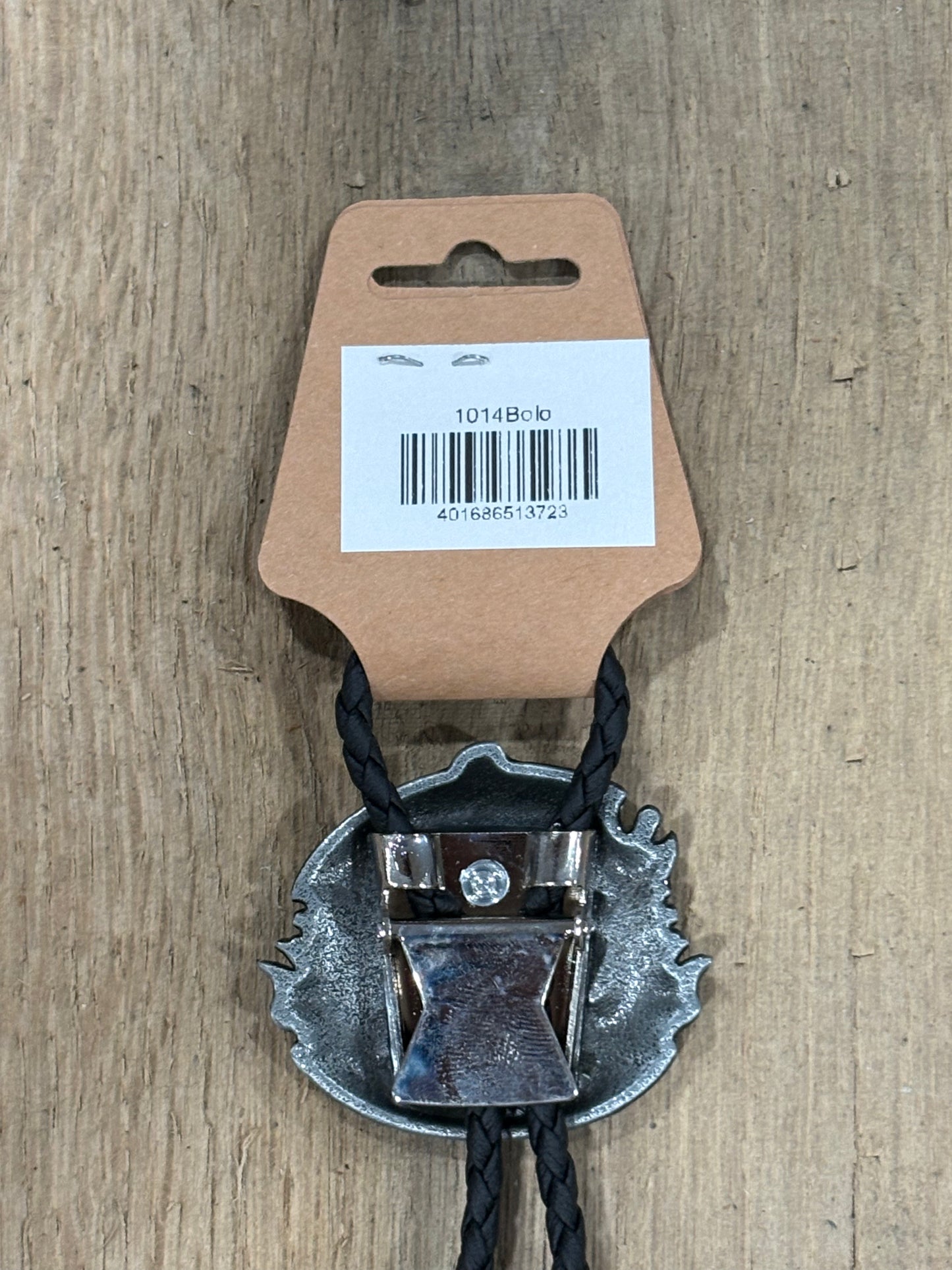Metal clip with black cord on a cardboard backing with a barcode on a wooden surface