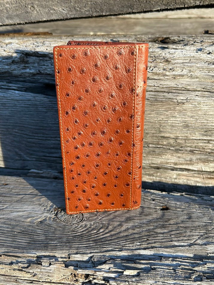 Brown leather wallet with a textured pattern on a wooden surface