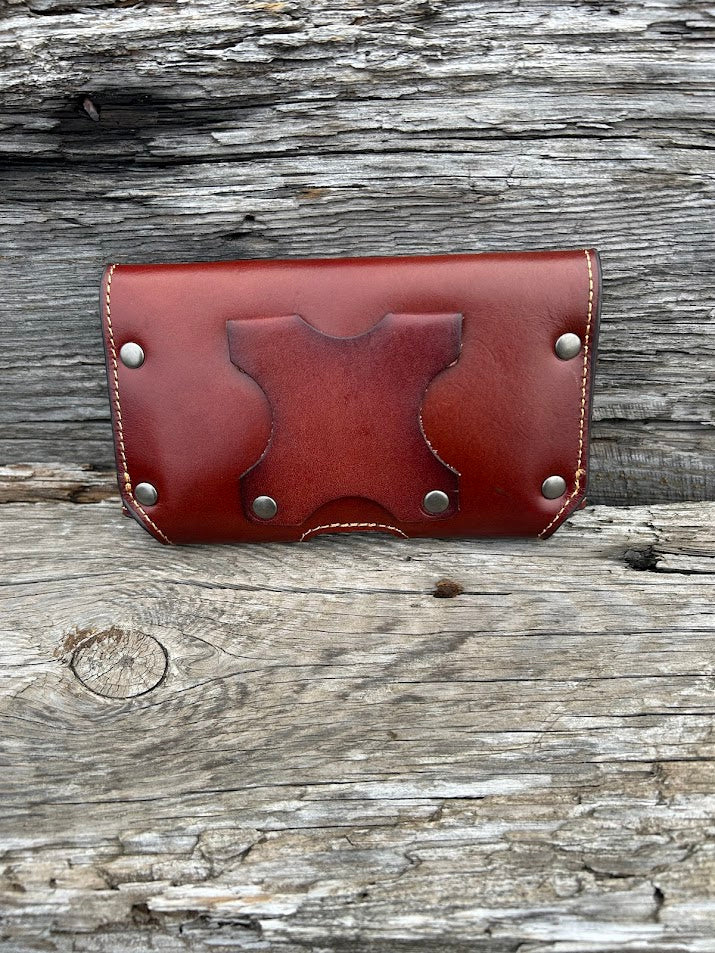Brown leather phone case with a embossed Praying Cowboy design. It has a smooth leather top, back, and a basketweave leather bottom. Rear view showing leather belt loop attachments.