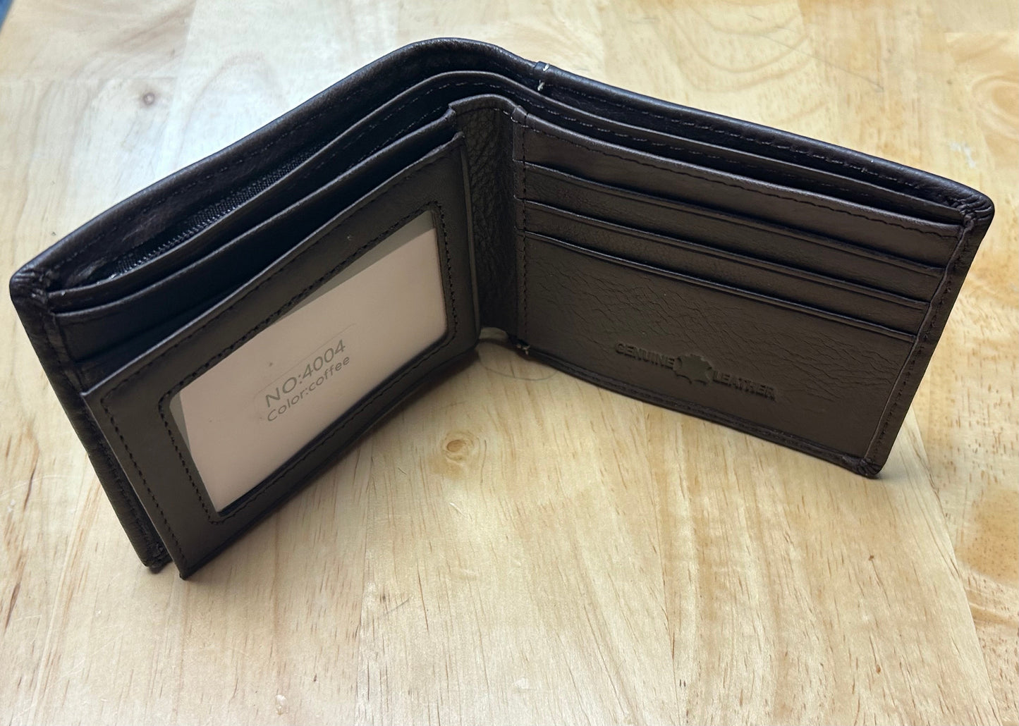 Black leather wallet with 'Novo' branding on a wooden surface