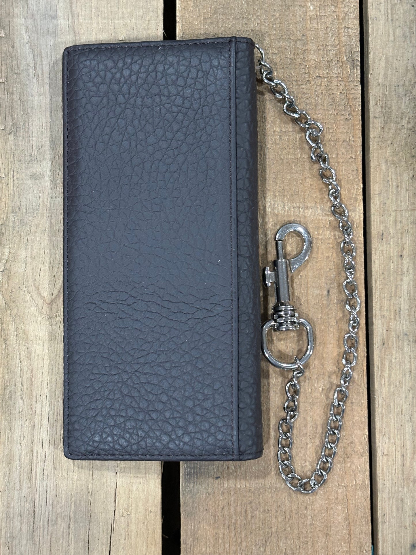 Black leather wallet with a chain on a wooden surface