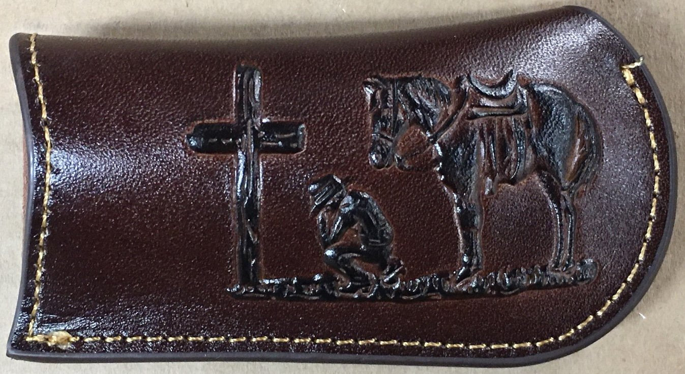 Coffee Brown leather case with black metal cross and horse and rider embossing on a beige background