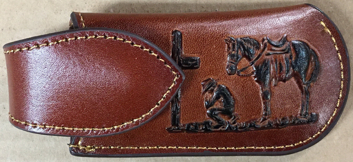 Brown leather sheath with embossed design of a person and horse on a beige background