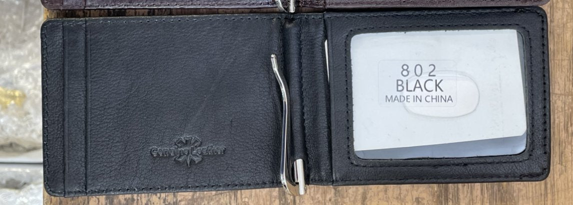 Black leather wallet with brand name and 'Made in China' label on a wooden surface