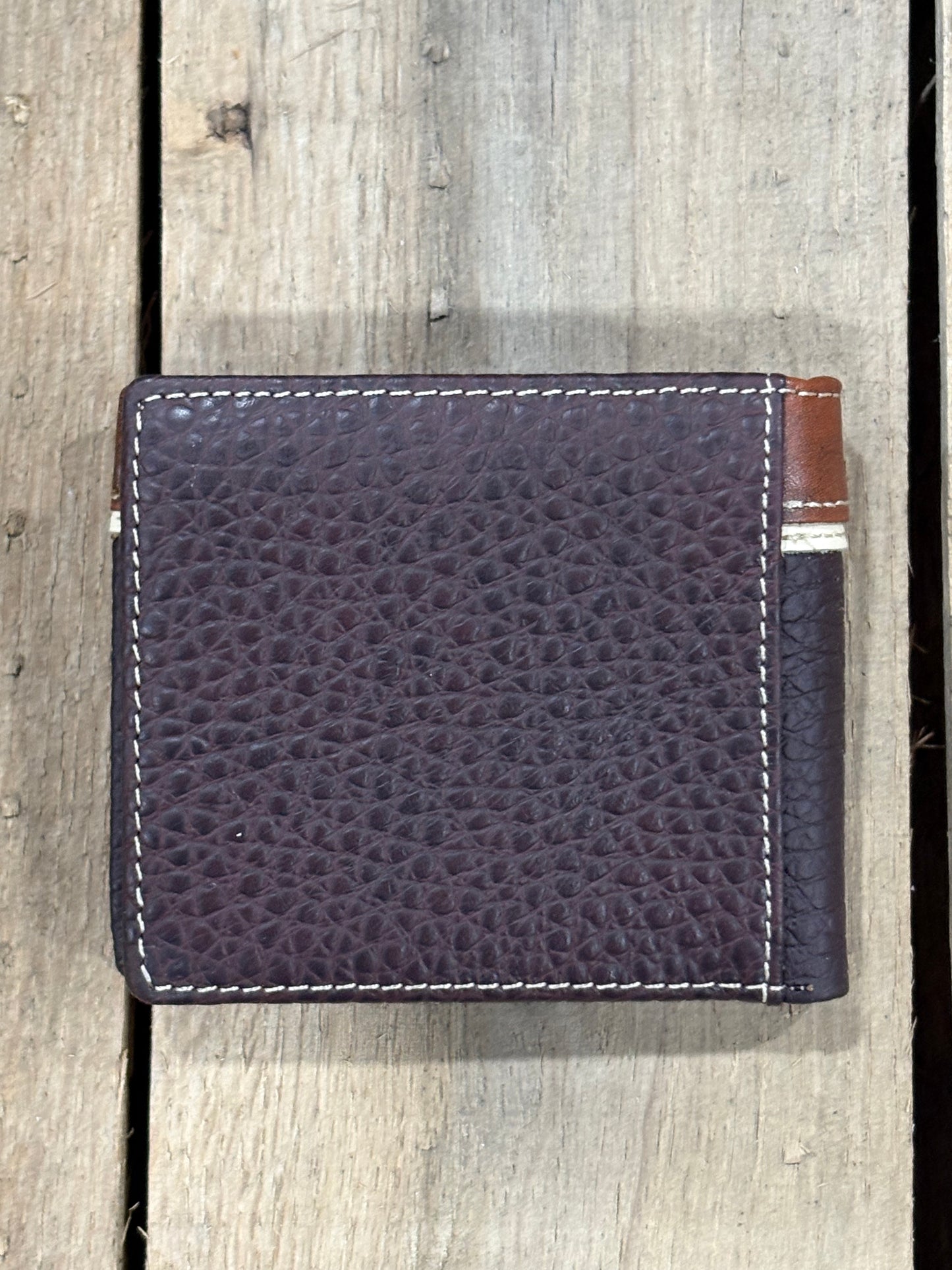 Coffee Brown pebbled leather wallet with visible stitching on a wooden surface
