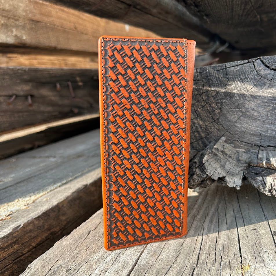 Brown leather wallet with embossed pattern on a wooden surface