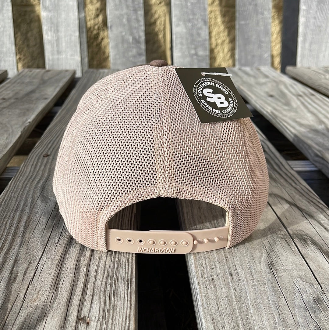 Beige mesh cap with a brand tag on a wooden surface