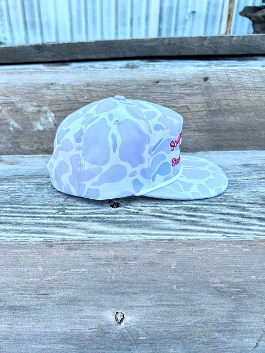 White cap with blue pattern on a wooden surface