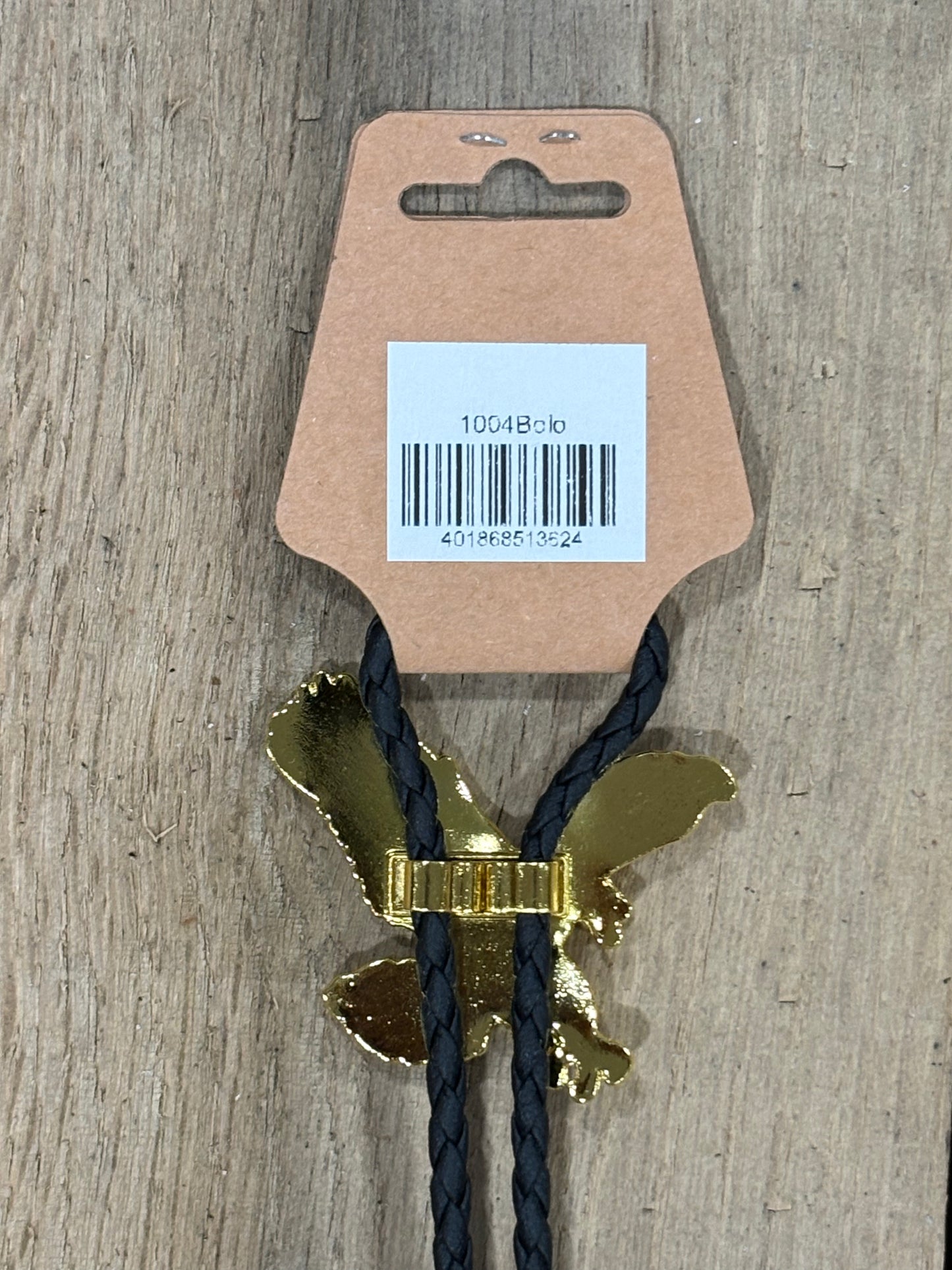Metal clip with black cord on a cardboard backing with a barcode on a wooden surface