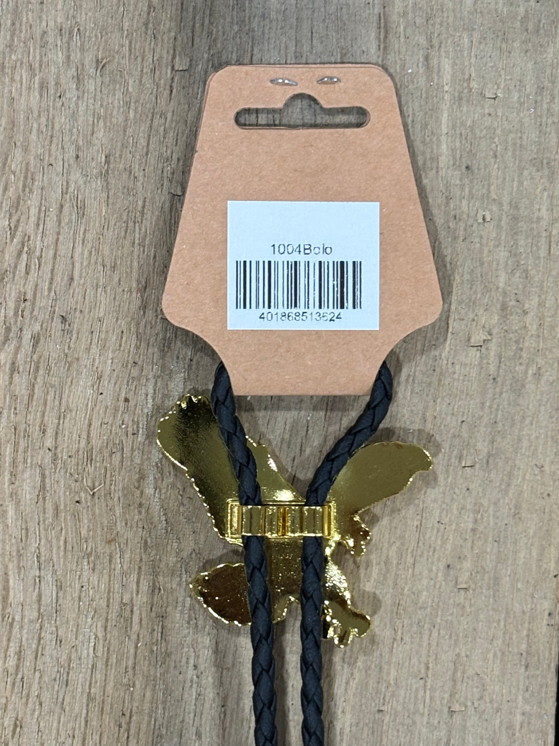 Metal clip with black cord on a cardboard backing with a barcode on a wooden surface