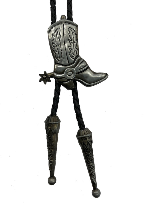 Metallic cowboy boot bolo tie on a white background