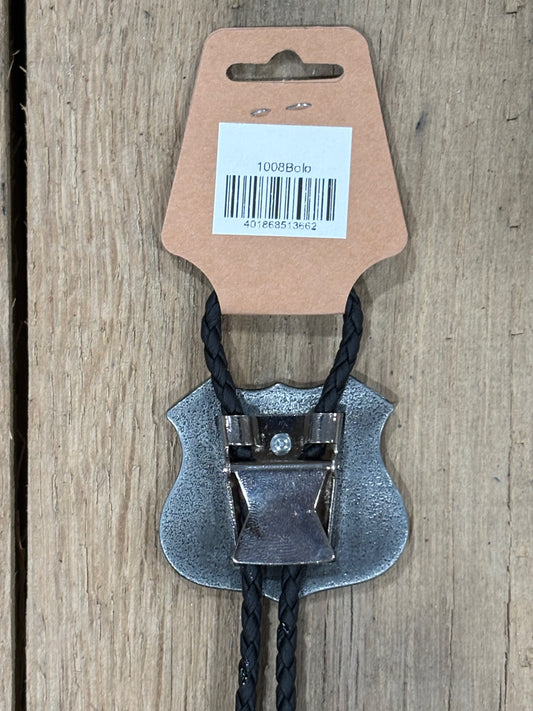 Metal clip with black cord on a cardboard backing with a barcode on a wooden surface