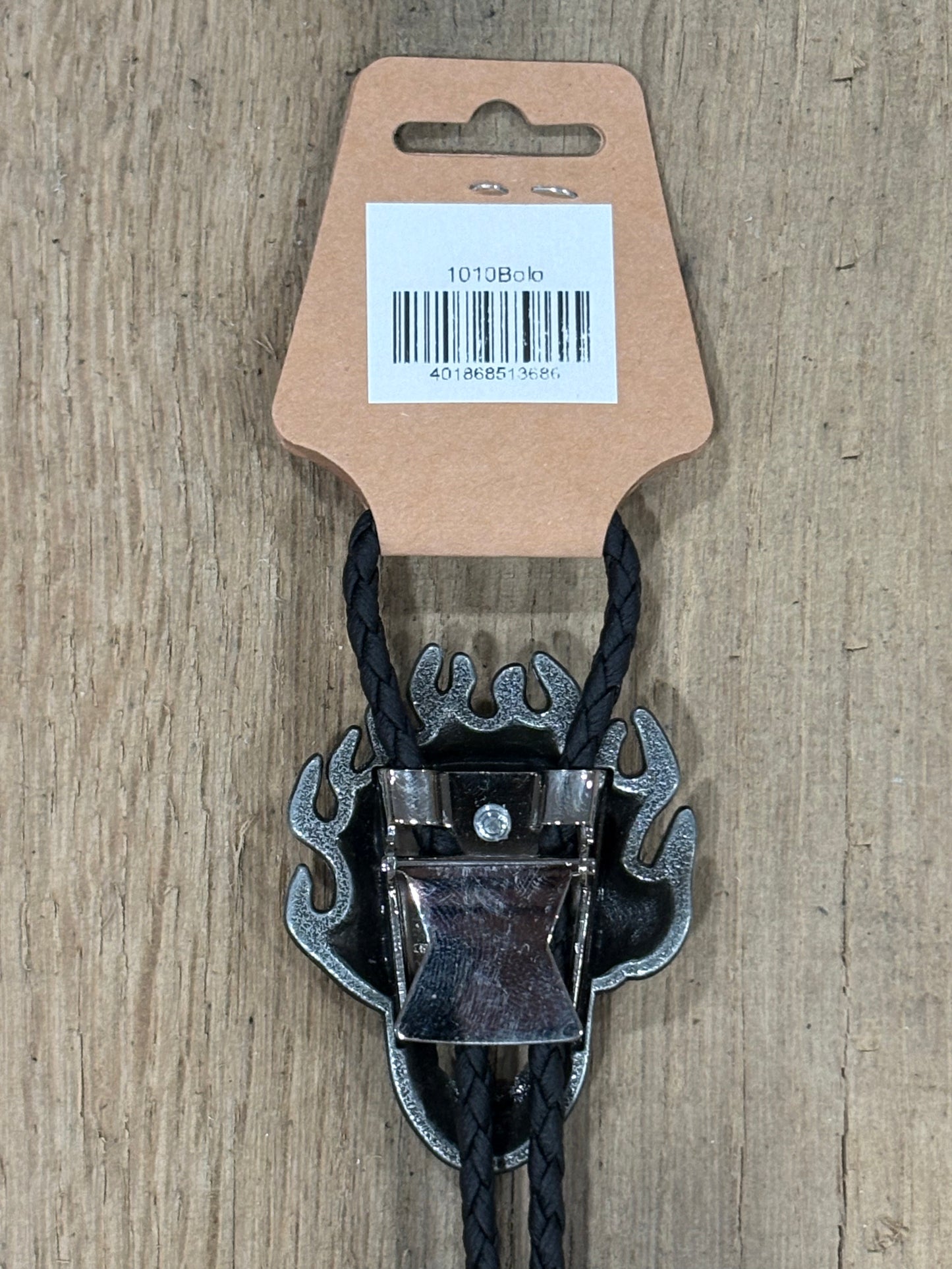Metal clip with black cord on a cardboard backing with a barcode on a wooden surface