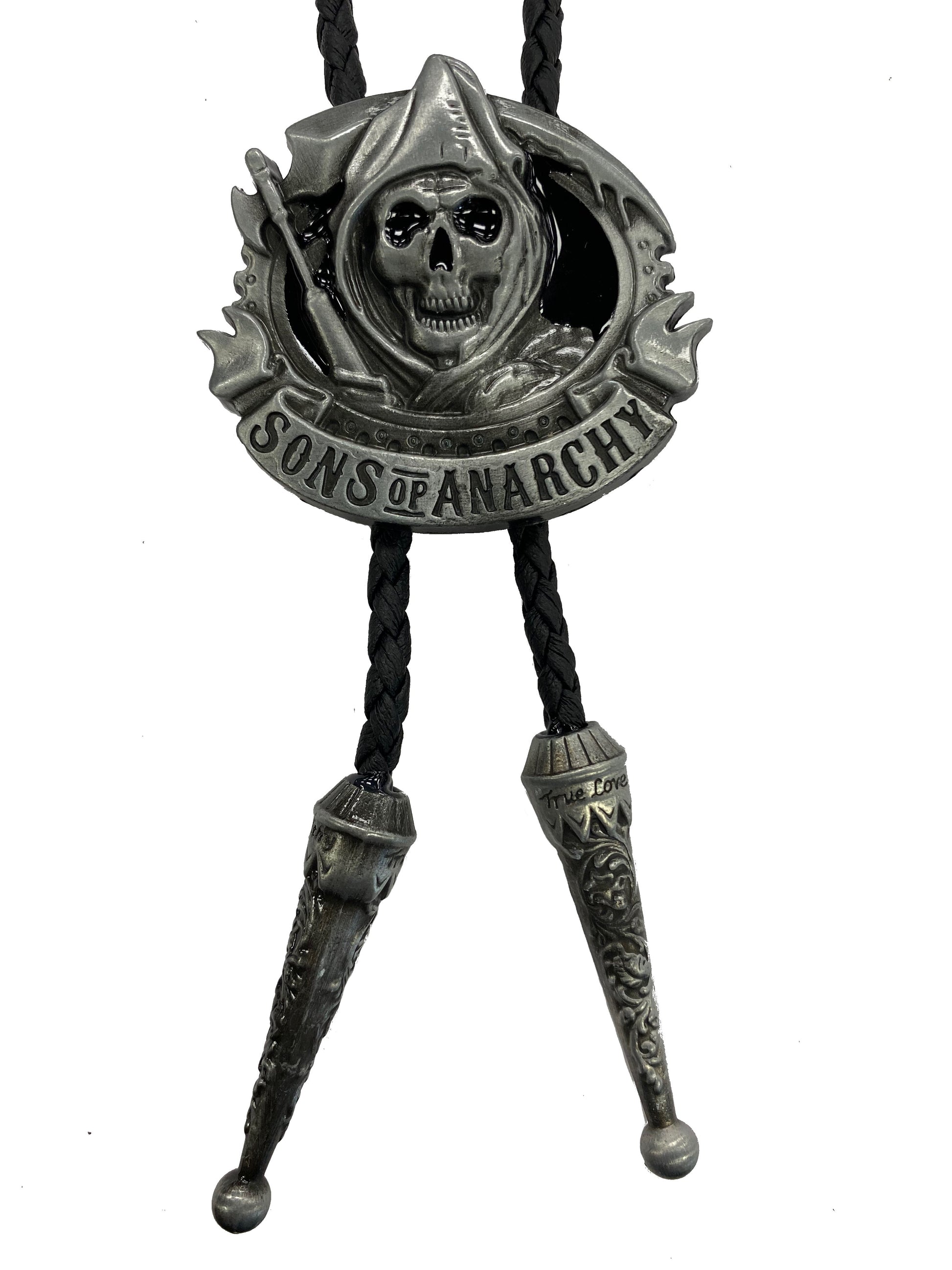 Bolo tie with 'Sons of Anarchy' design featuring a skull and crossed swords on a white background.