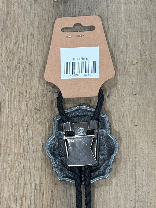 Metal clip with black cord on a cardboard backing with a barcode on a wooden surface