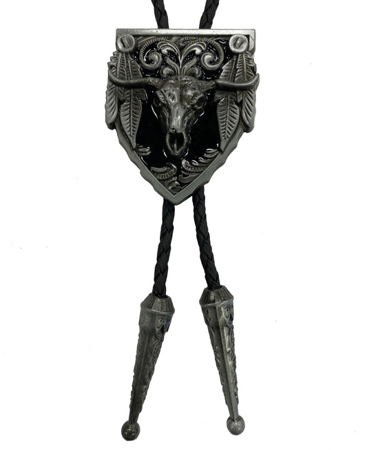 Black and silver bolo tie with intricate design of longhorn and feathers on a white background