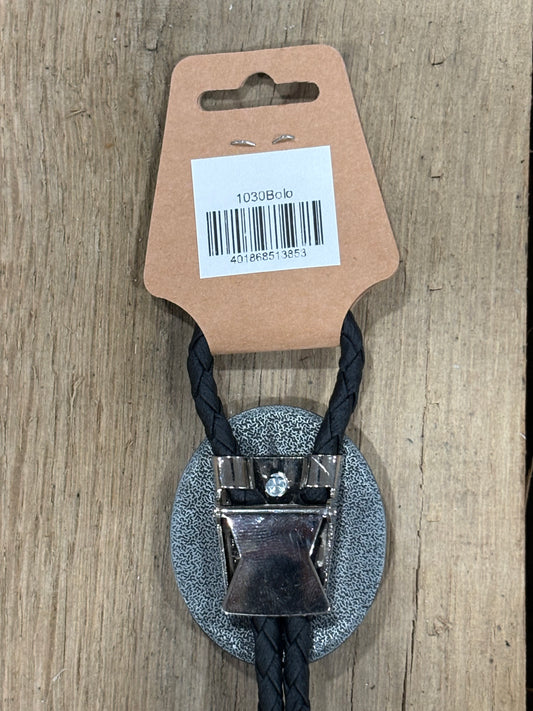Metal clip with black cord on a cardboard backing with a barcode on a wooden surface