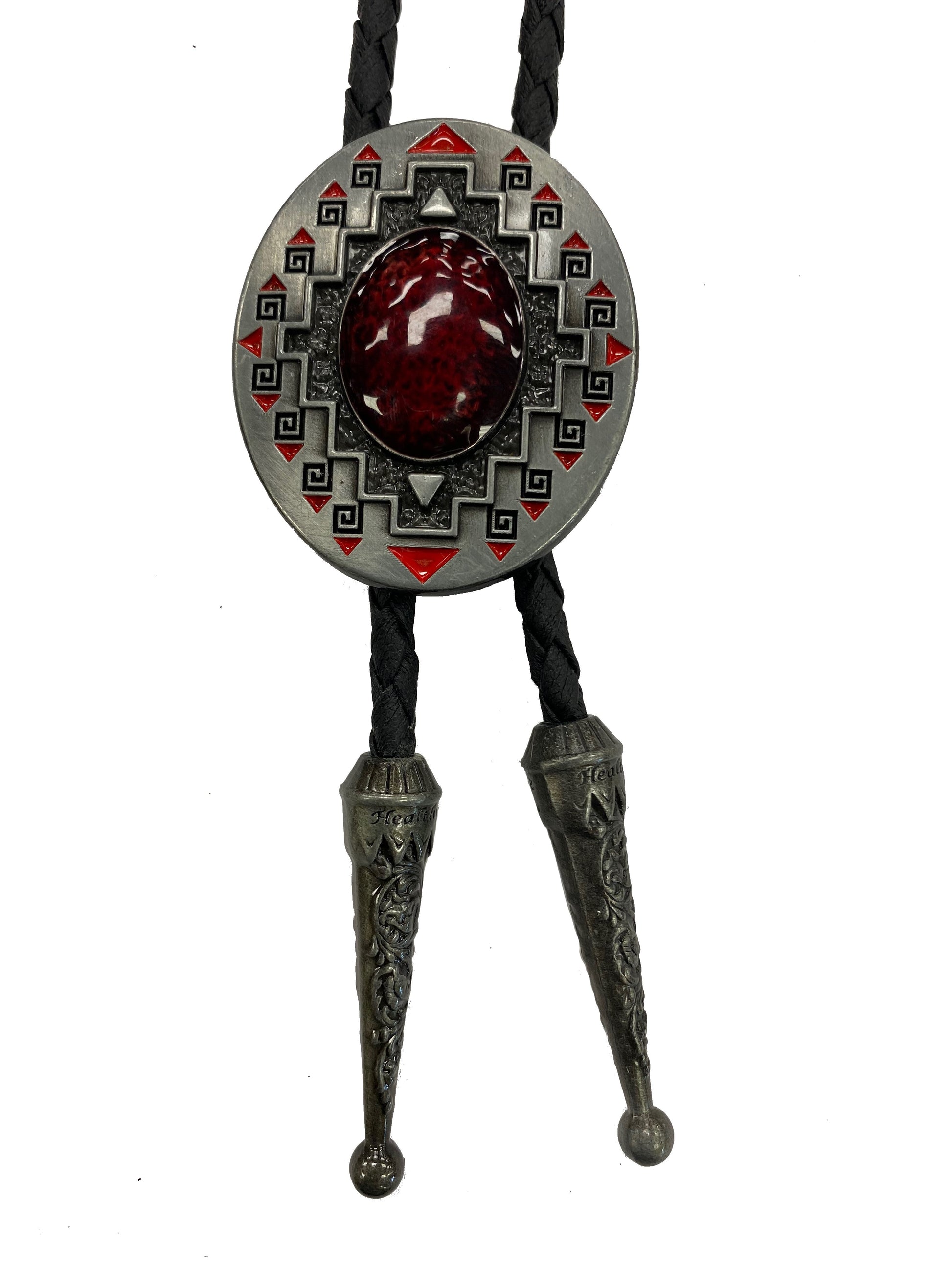 Bolo tie with decorative red stone and geometric Southwest patterns on a white background