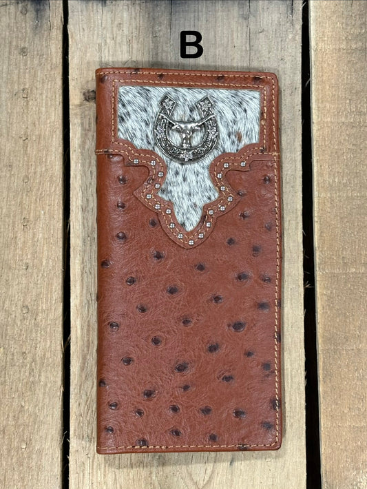 Brown leather wallet with cowhide pattern and horseshoe and longhorn concho on a wooden surface