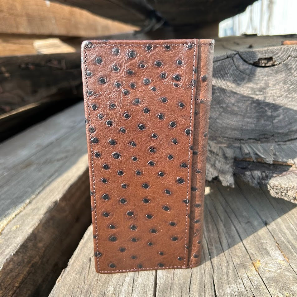 Coffee Brown leather wallet with embossed pattern on a wooden surface