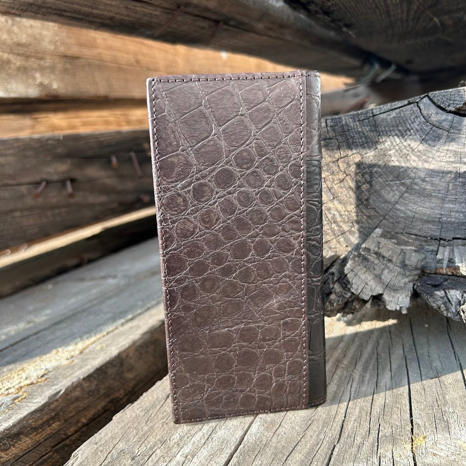 Coffee Brown leather wallet with crocodile texture on a wooden surface
