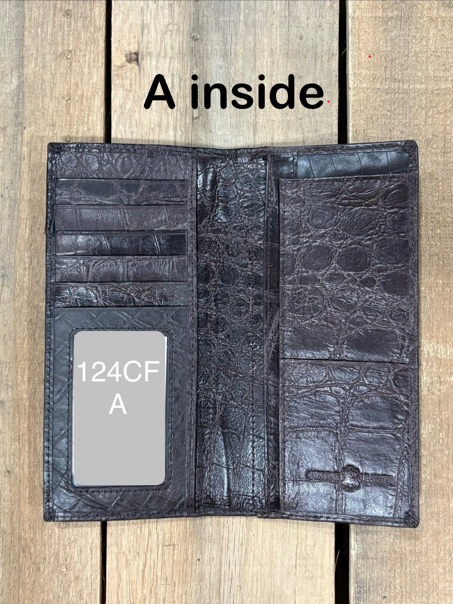 Open Coffee Brown leather wallet on a wooden surface with 'A inside' text.