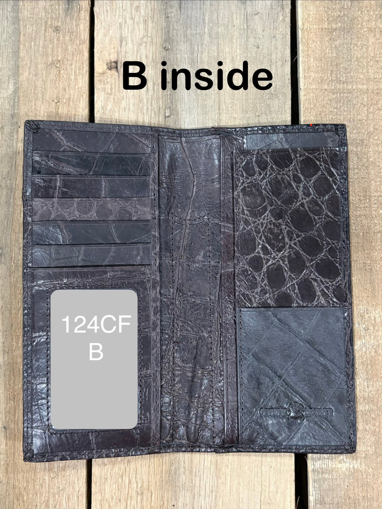 Open Coffee Brown leather wallet on a wooden surface with 'B inside' text.