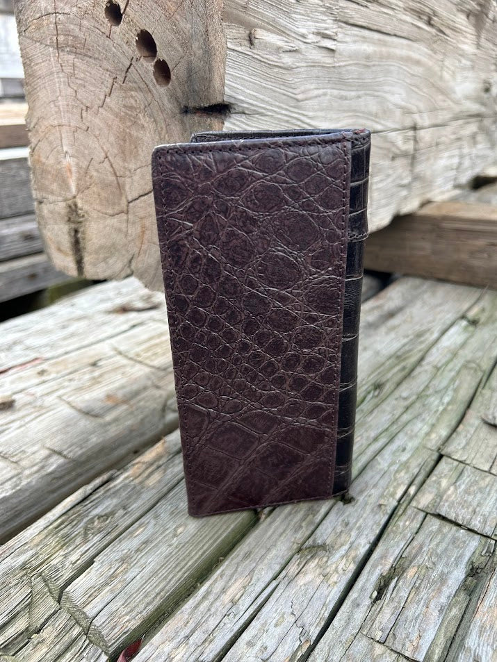 Coffee Brown leather wallet with crocodile texture on a wooden surface