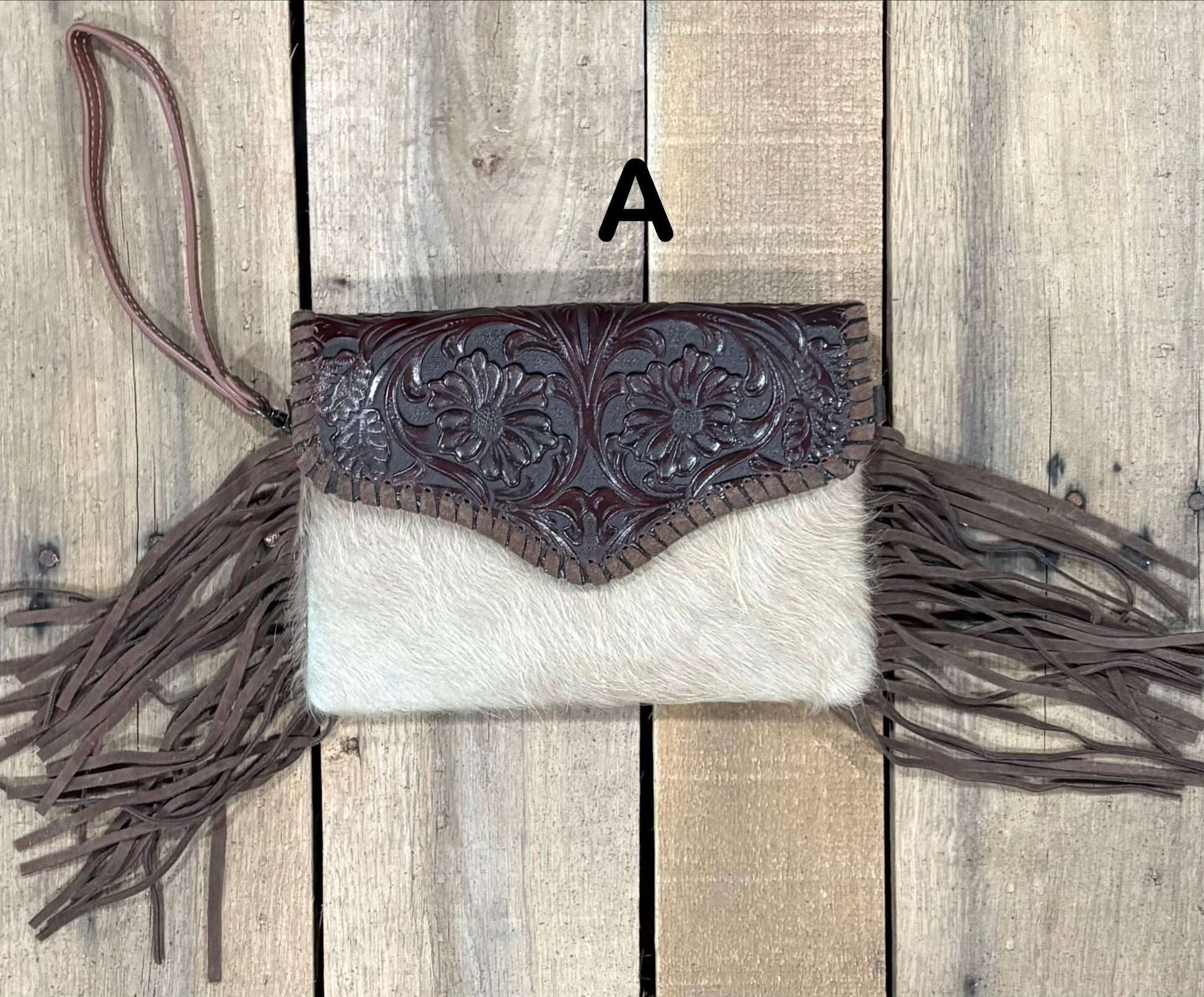 Coffee Brown tooled leather and cowhide bag with side fringe. This bag has both a wristlet and should strap. Front View