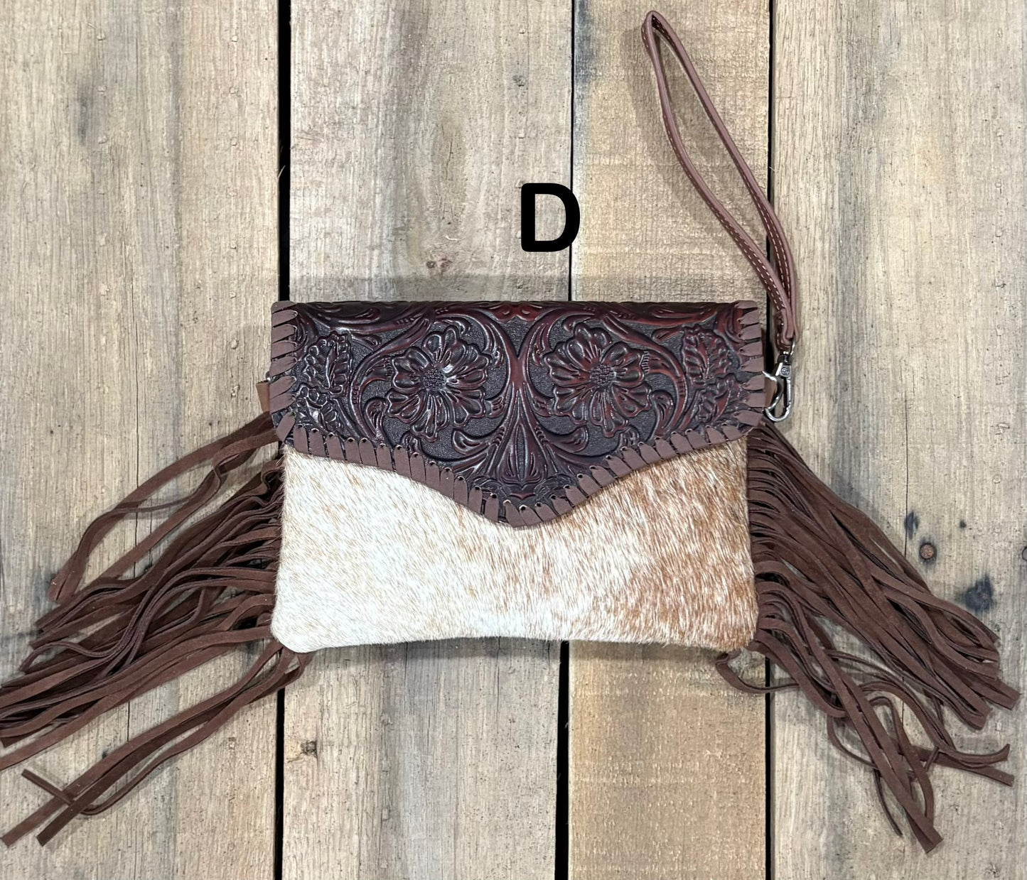 Coffee Brown tooled leather and cowhide bag with side fringe. This bag has both a wristlet and should strap. Front View