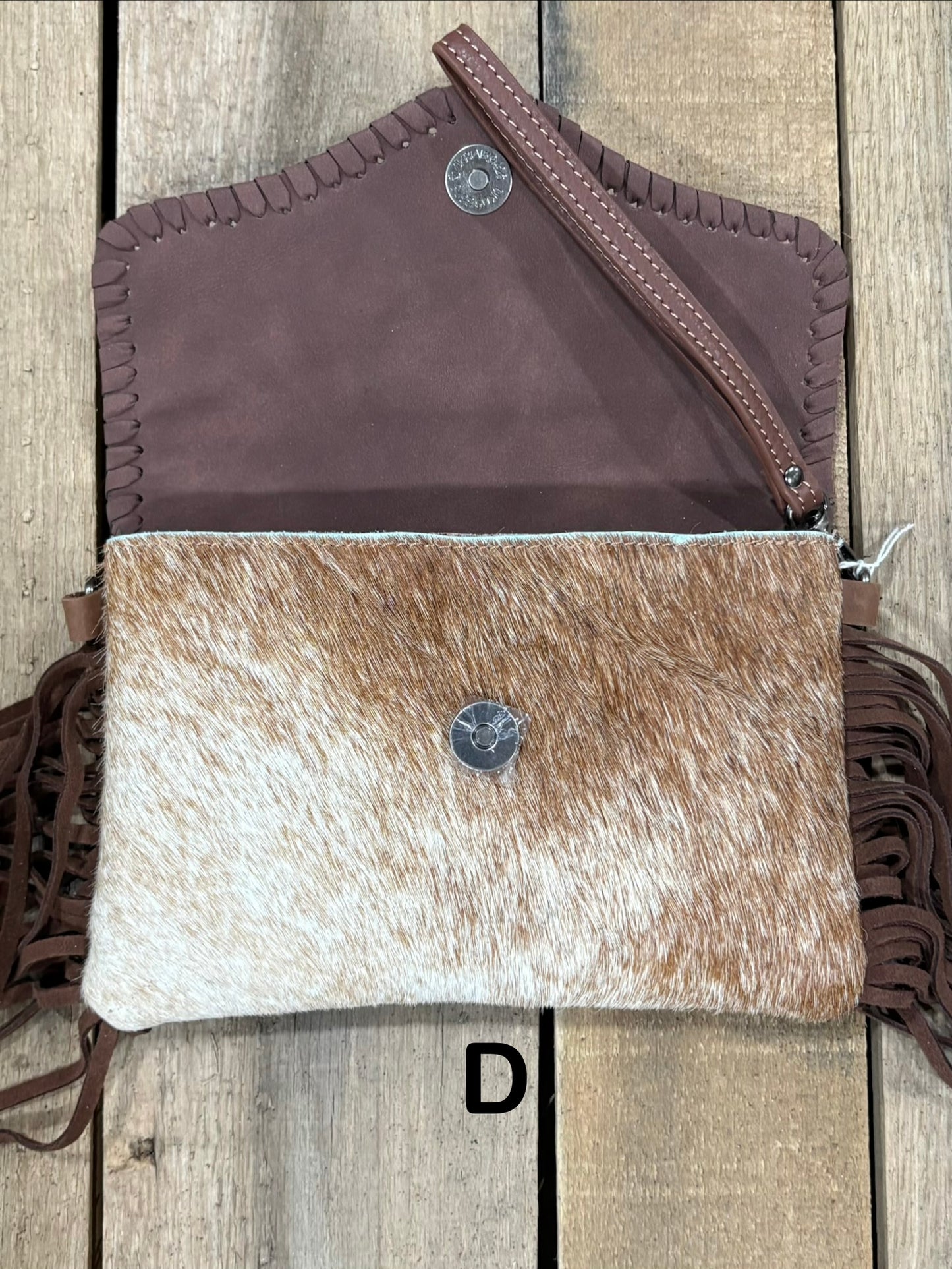 Coffee Brown tooled leather and cowhide bag with side fringe. This bag has both a wristlet and should strap. Front View