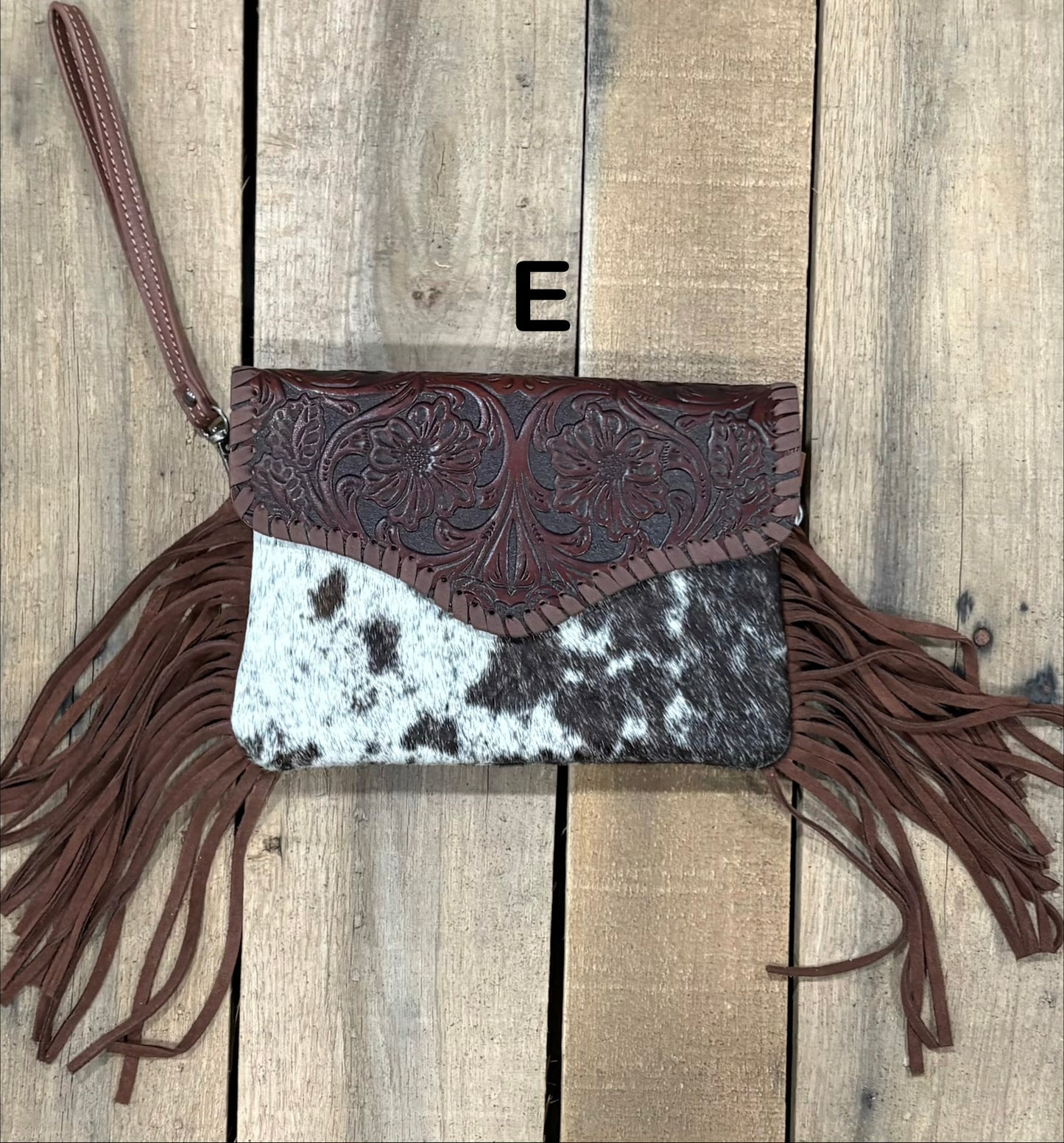 Coffee Brown tooled leather and cowhide bag with side fringe. This bag has both a wristlet and should strap. Front View