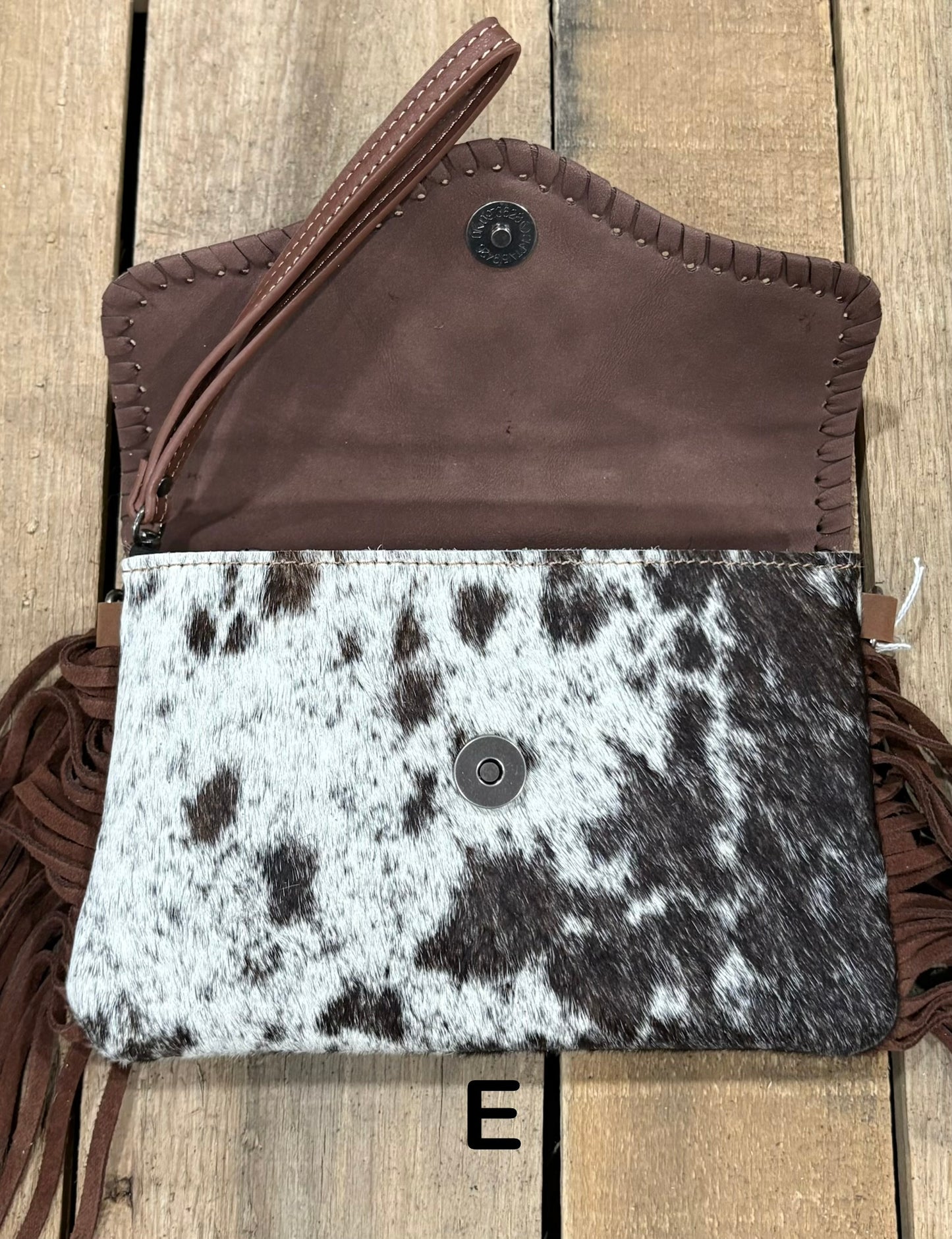 Coffee Brown tooled leather and cowhide bag with side fringe. This bag has both a wristlet and should strap. Front View
