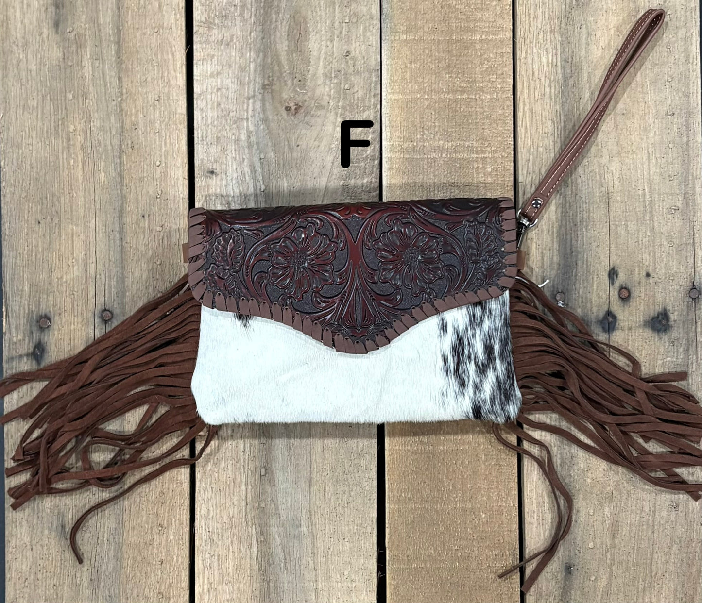 Coffee Brown tooled leather and cowhide bag with side fringe. This bag has both a wristlet and should strap. Front View