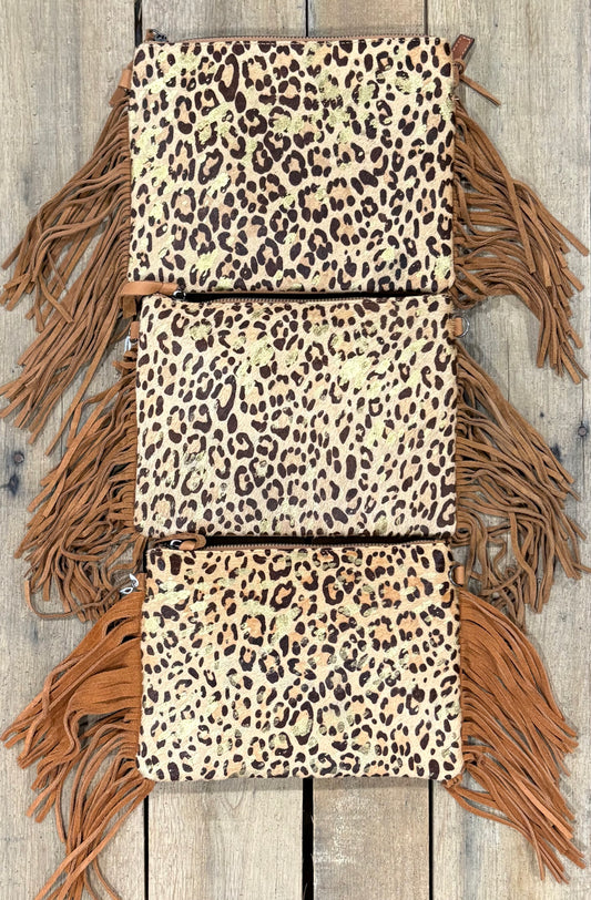 Three purse view of leopard crossbodys on a wooden background