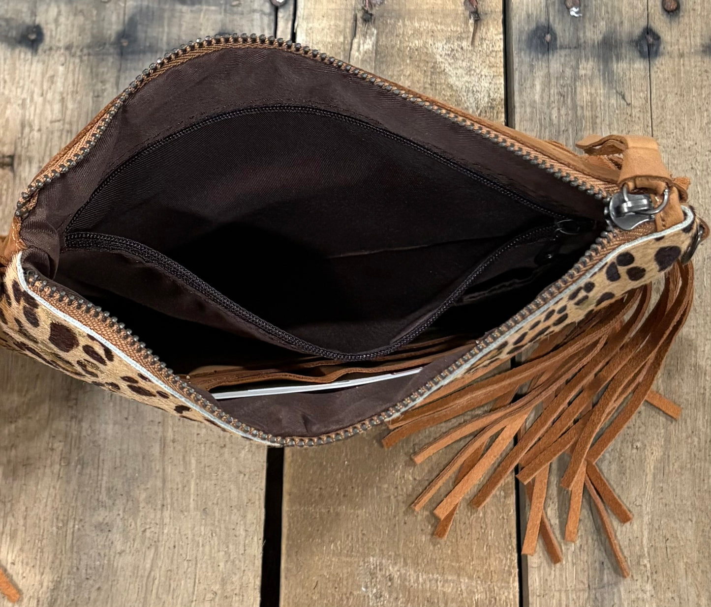 Inside Zipper view of a brown leopard crossbody purse.