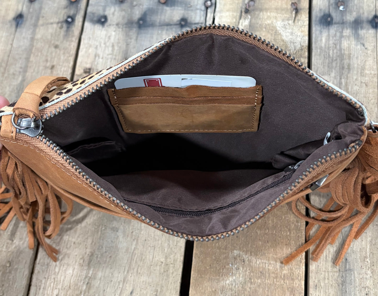 Card slot view of a beige cowhide crossbody purse.