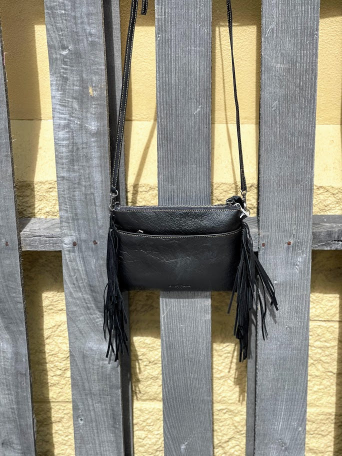 This Pink and Black cowhide leather fringe back has a adjustable shoulder strap.  Rear view