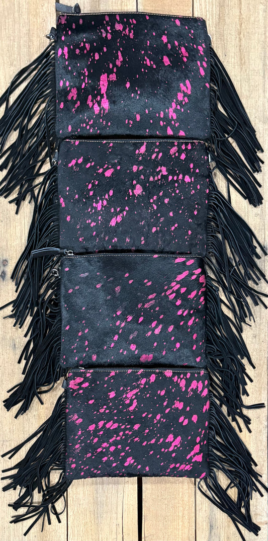 Four purse view of Pink and black hairon crossbodys on a wooden background