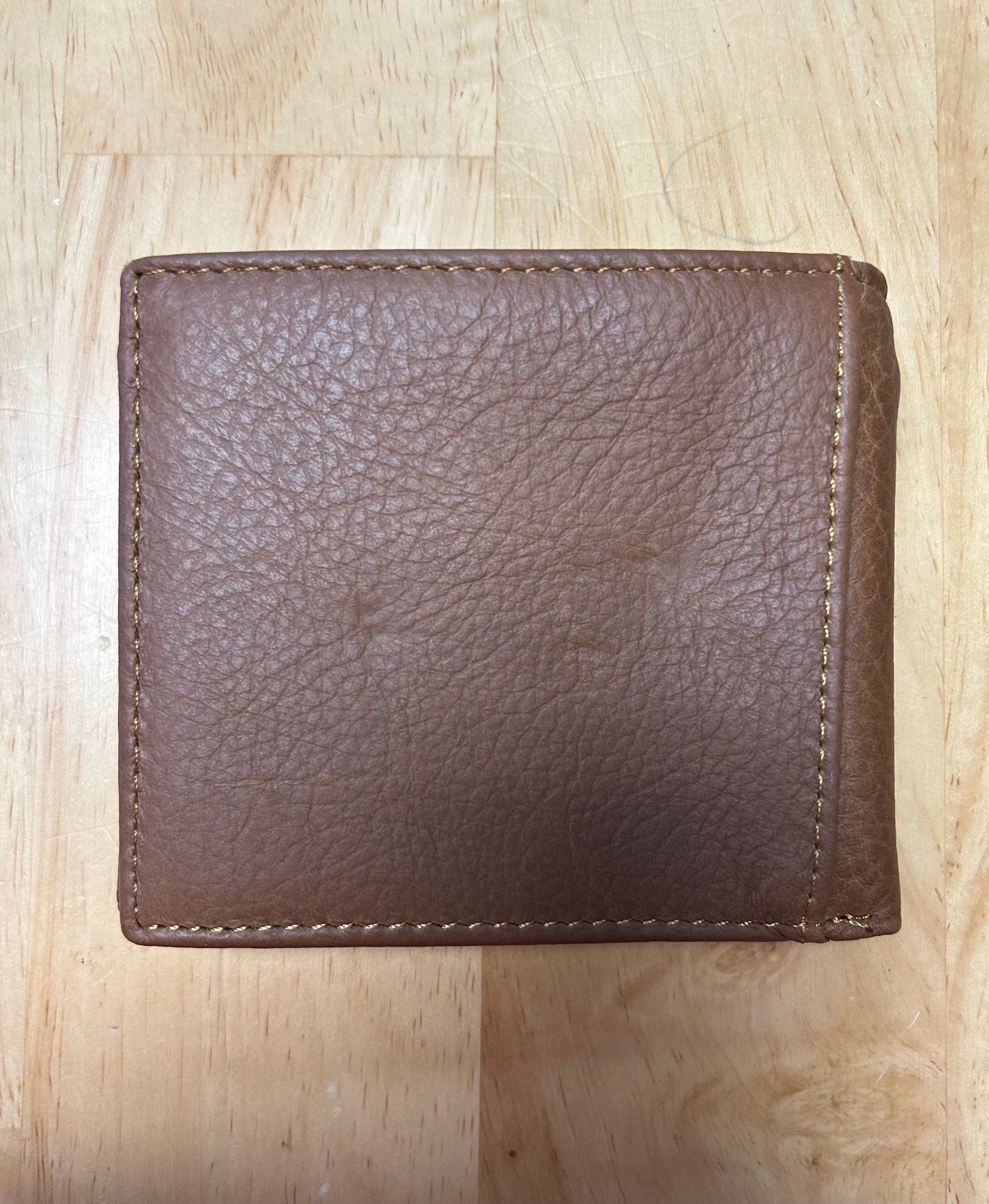 Brown leather wallet on a wooden surface