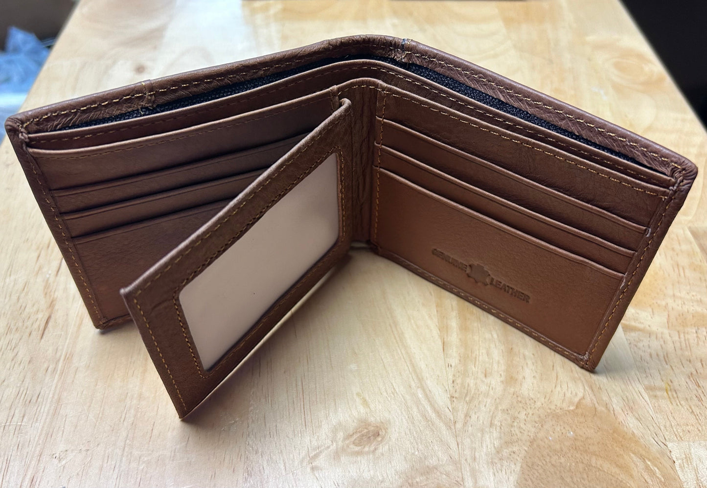 Brown leather wallet with card slots on a wooden surface