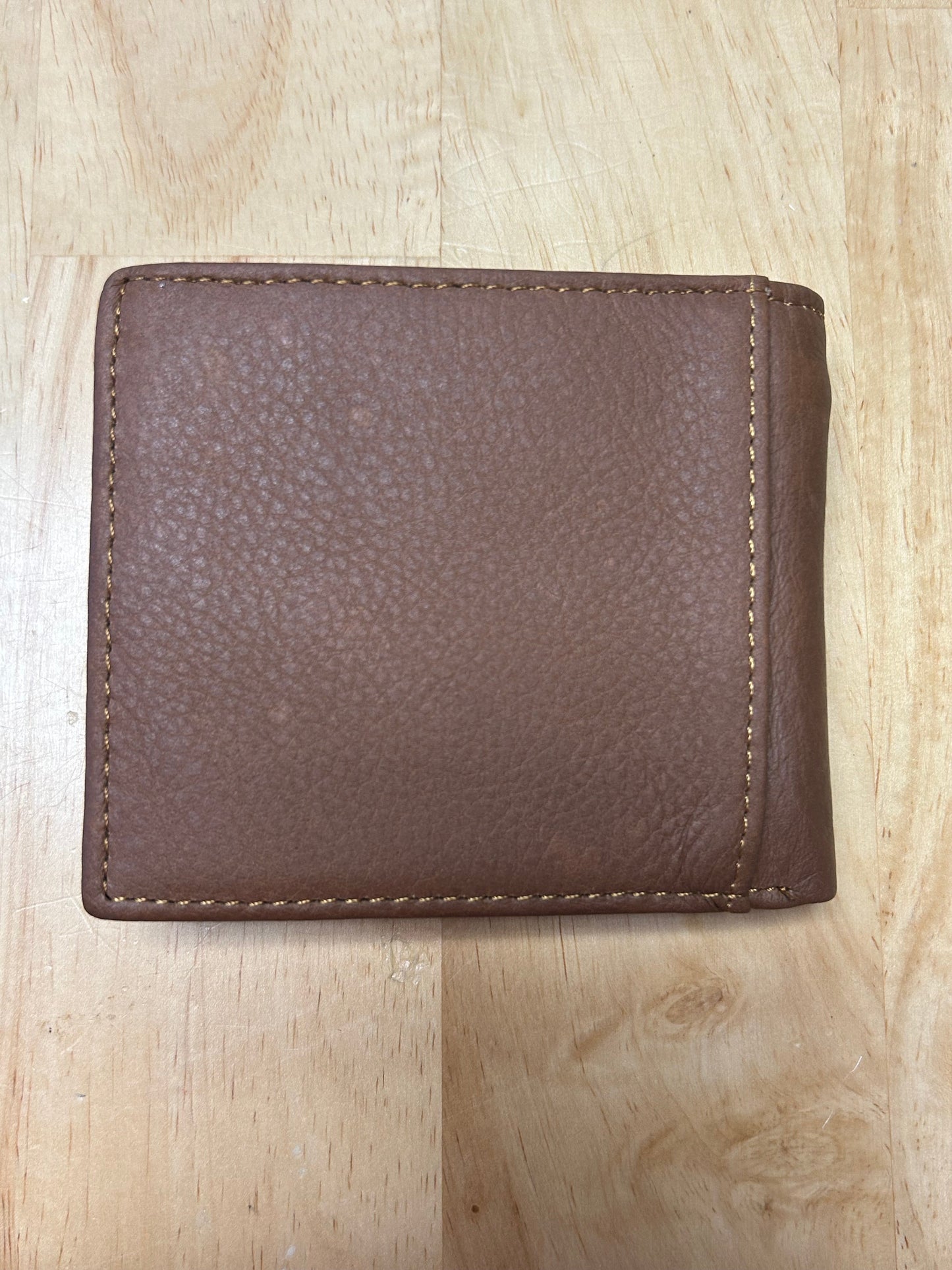 Brown leather wallet on a wooden surface