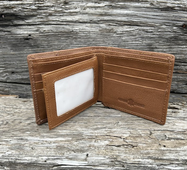 This Brown leather bifold wallet features a cowhide inlay with a Shotgun Shell Concho.  Inside view showing card slots and dual ID window.