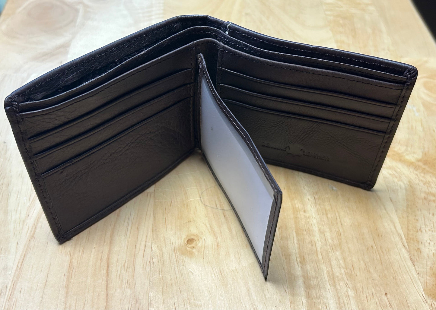 Coffee Brown leather wallet open on a light wooden surface