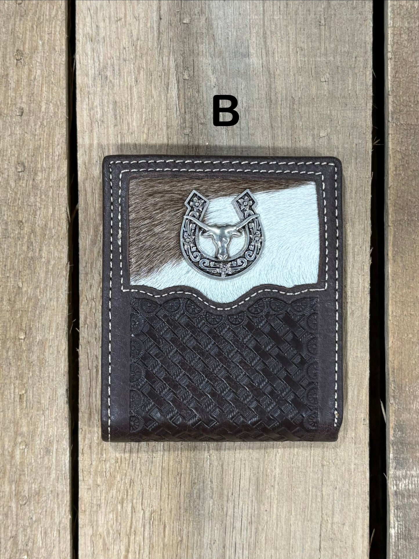 Coffee Brown leather wallet with embossed basketweave design and horseshoe and longhorn concho on a wooden surface
