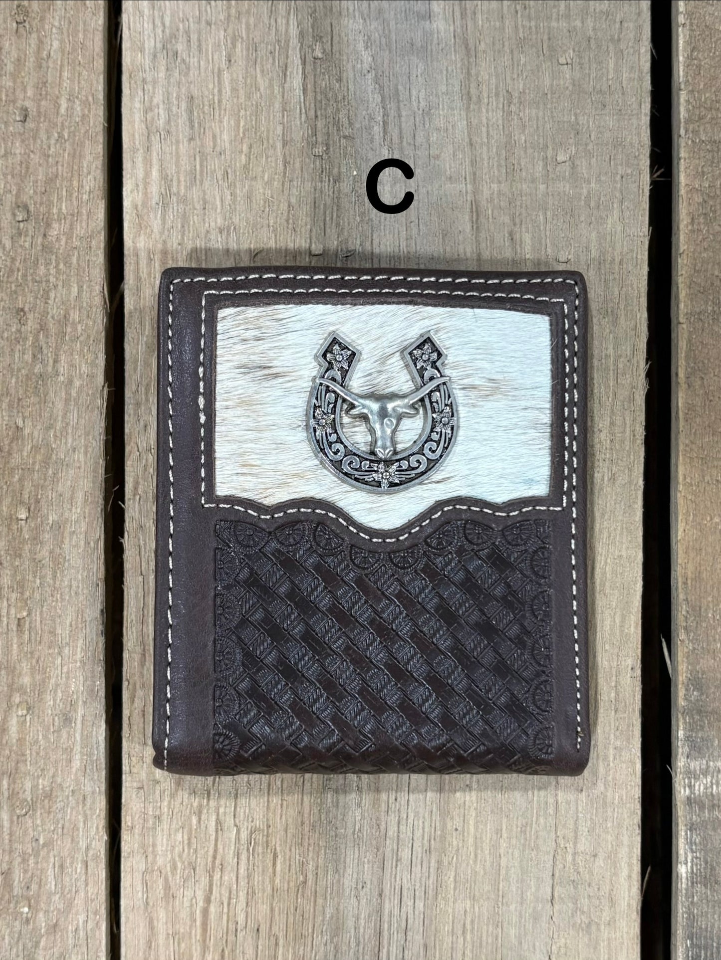 Coffee Brown leather wallet with embossed basketweave design and horseshoe and longhorn concho on a wooden surface